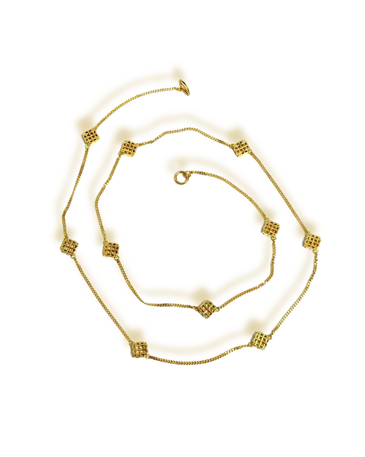 A set of vintage jewelry including a necklace, bracelet, earrings, and ring, with gold plating and geometric motifs.