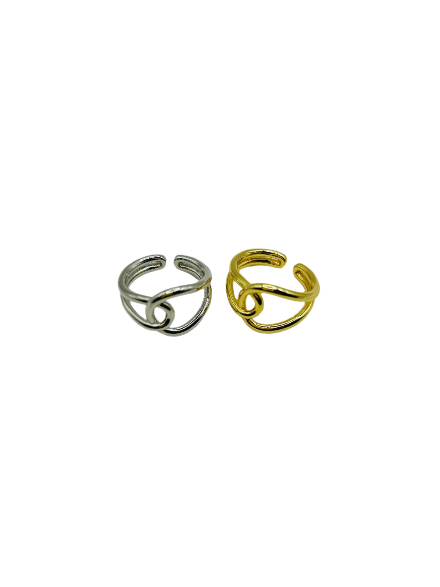 Two open rings, one silver and one gold, on a white background