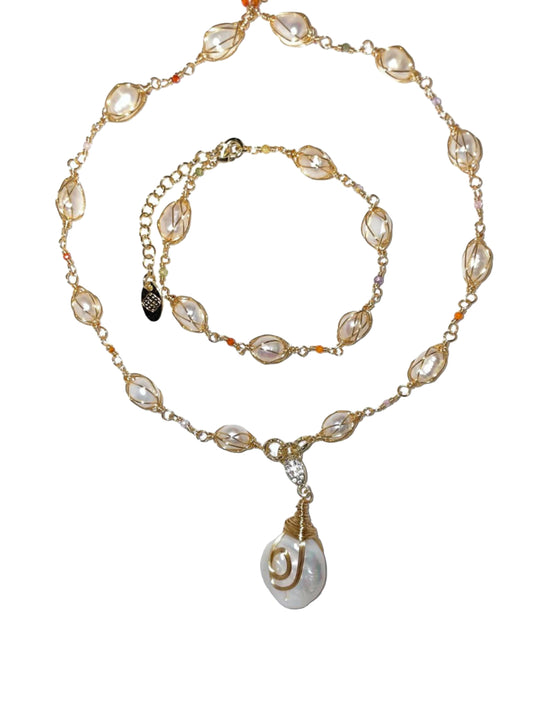 An 18k gold-plated chain necklace and bracelet set featuring a off-white abalone shell pendant.