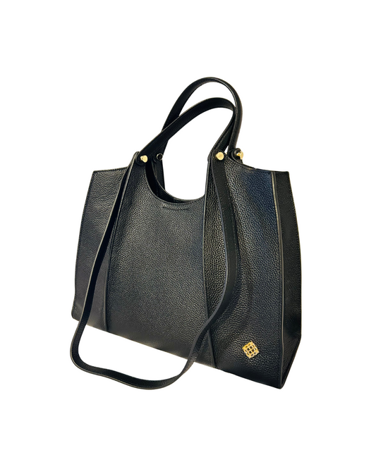 Black handbag with a strap on a white background