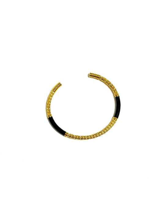 An 18k gold-plated c-shaped cuff bangle bracelet with gold-tone metalwork and multicolored enamel detailing.