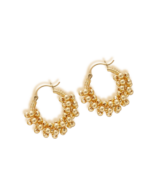Eva Earring Gold hoop earrings with bead detailing on a white background. Eva gold hoop earrings with clustered bead design on white background.