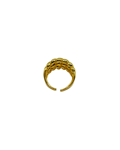 Gold ring with a textured design on a white background