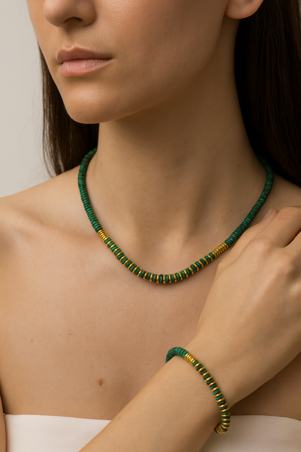 Geena Set necklace and bracelet in green malachite-style beads with gold accents on a model