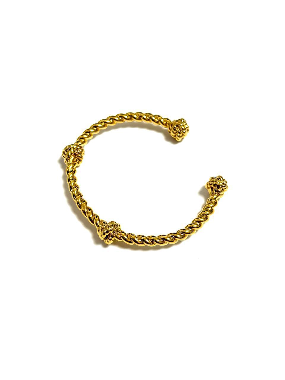 An 18k gold-plated vintage cuff bracelet with a yellow gold rope and intricate knot detailing.