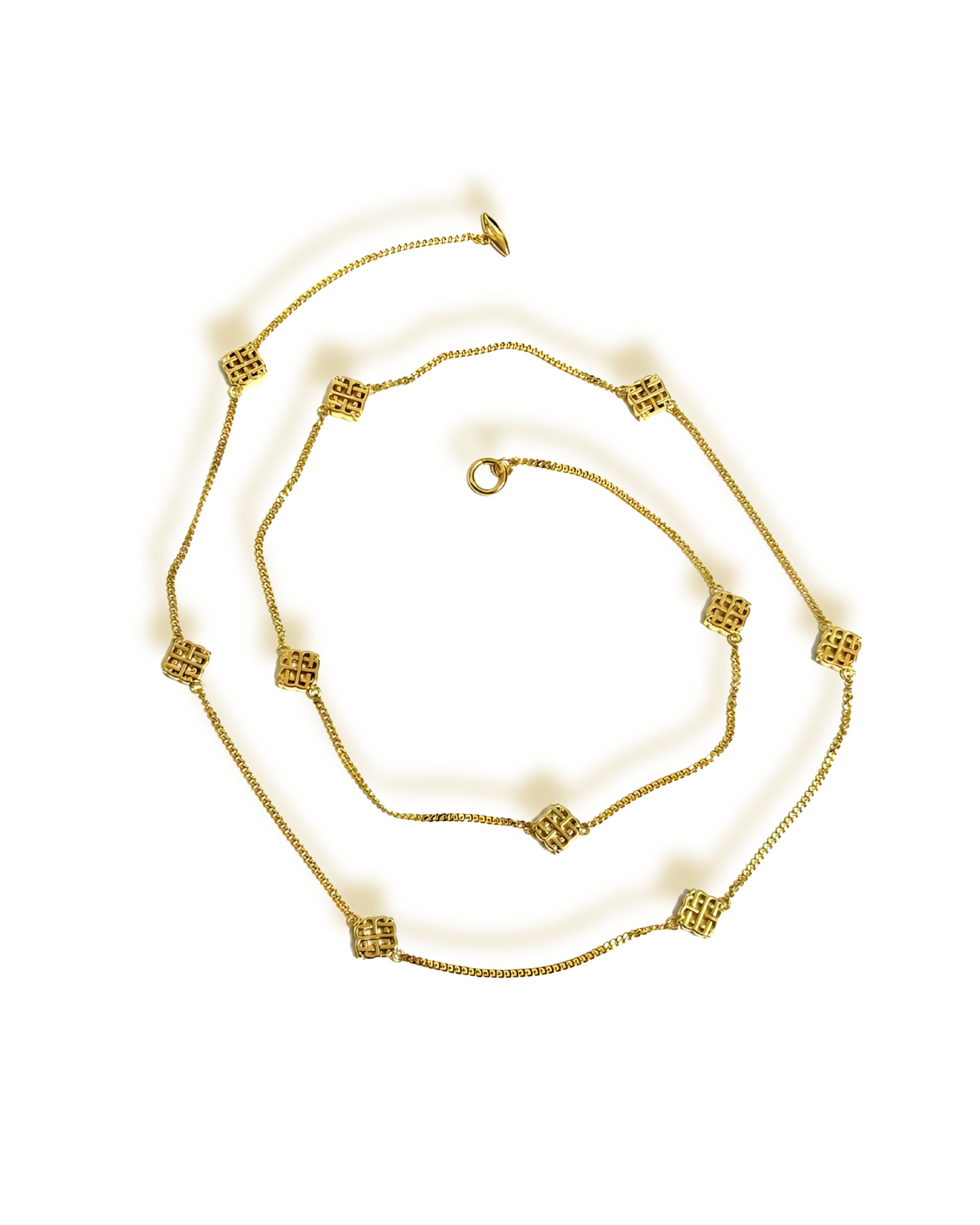 A set of vintage jewelry including a necklace, bracelet, earrings, and ring, with gold plating and geometric motifs.