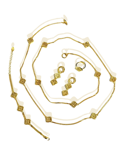 A set of vintage jewelry including a necklace, bracelet, earrings, and ring, with gold plating and geometric motifs.