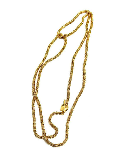 A long, coiled design plated necklace with a toggle clasp, featuring mixed metals and colors silver and gold.
