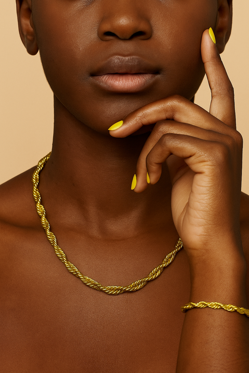 Woman wearing a gold necklace and bracelet with a neutral background. Vanessa Set gold necklace and bracelet laid flat showing clasp and extender.