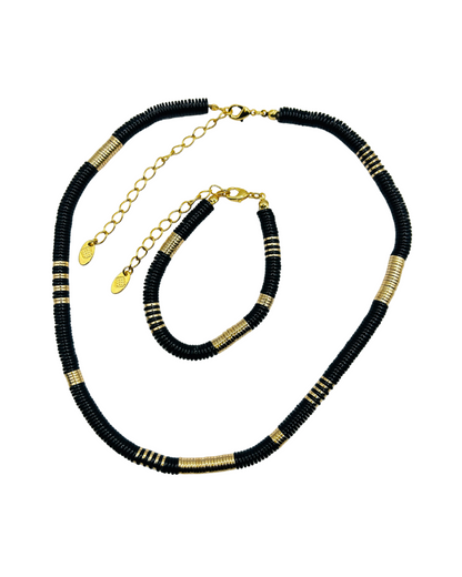 Black and gold beaded necklace on a white background