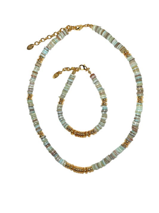 A set of jewelry featuring a green heishi necklace and bracelet with gold-plated beads and clasp fastening.