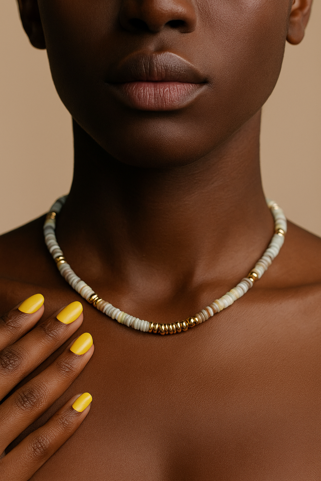 Women set of jewelry featuring a green heishi necklace and bracelet with gold-plated beads and clasp fastening.