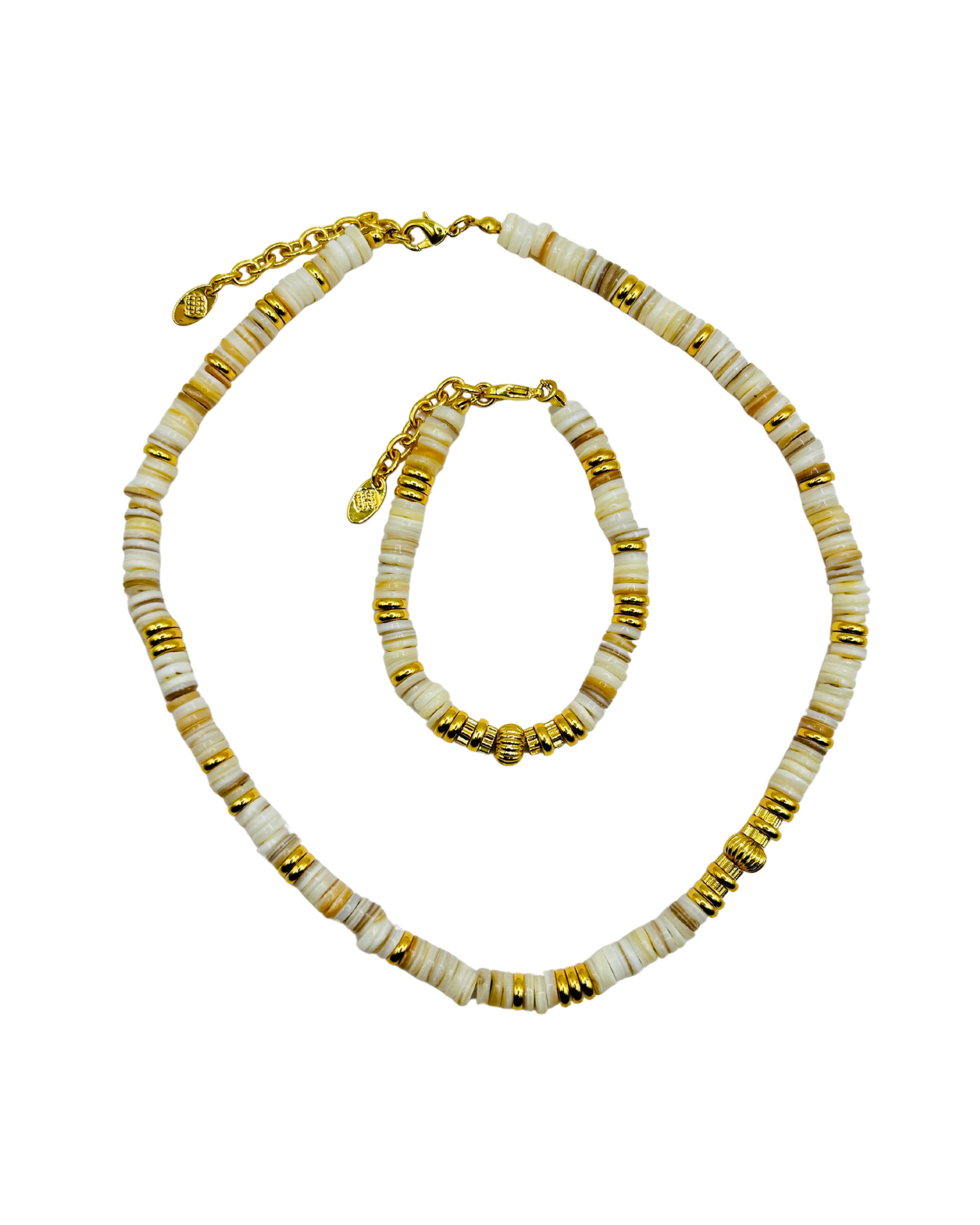 Necklace and bracelet set with gold and white beads on a white background