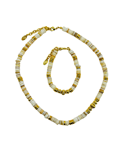 Necklace and bracelet set with gold and white beads on a white background
