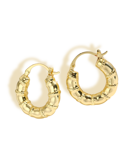 Tessa Earring A pair of gold-plated brass hoop earrings with a bamboo-inspired design, featuring textured ridges and a polished finish.