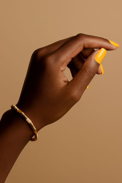 Bracelet close-up of yellow agate beads and gold accents bracelet from the Tina jewelry set.