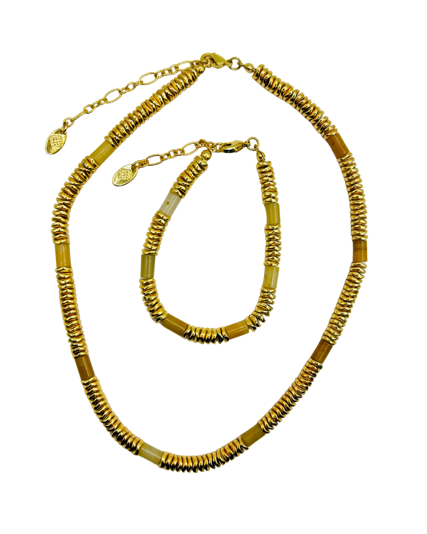 Gold necklace and bracelet set on a white background