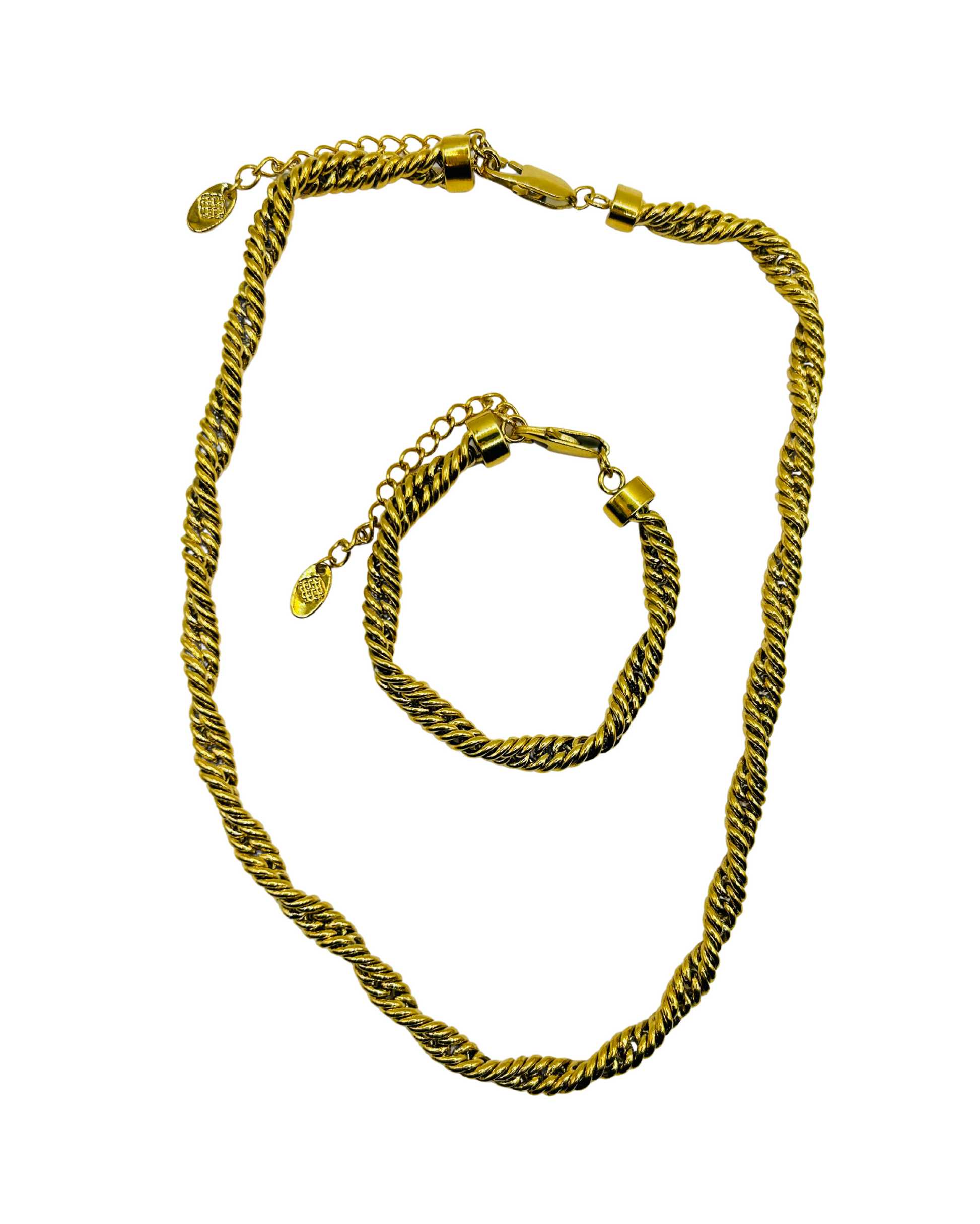 Gold necklace and bracelet set on a white background