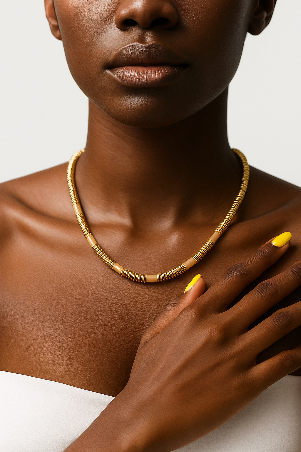 Female Tina Set yellow agate beaded necklace and bracelet with gold spacers on white background.