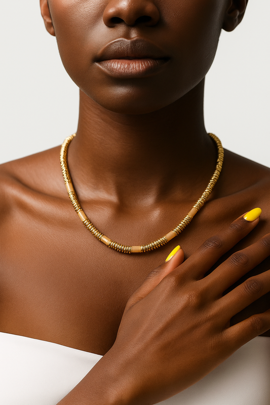 Female Tina Set yellow agate beaded necklace and bracelet with gold spacers on white background.